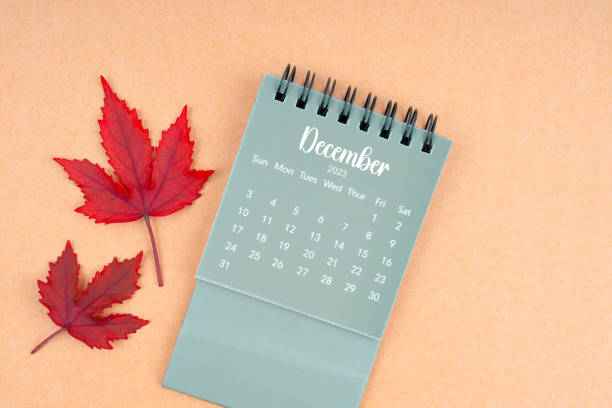 istock December 2023 monthly calendar and fall leaves. 1943362627