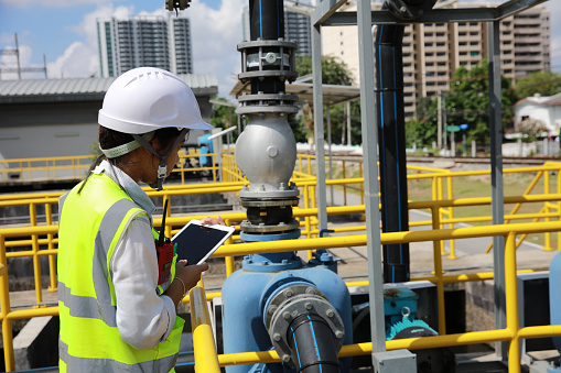 An advanced safety engineer inspects the wastewater system of the waterworks, and Maintenance for the control system of the wastewater treatment system