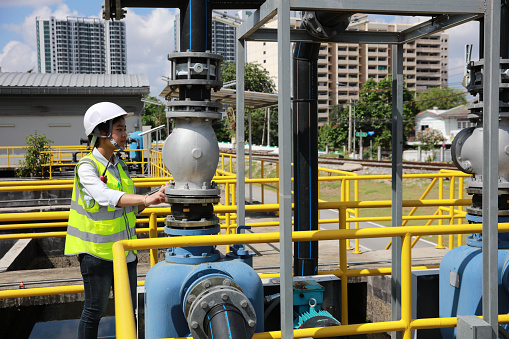 An advanced safety engineer inspects the wastewater system of the waterworks, and Maintenance for the control system of the wastewater treatment system