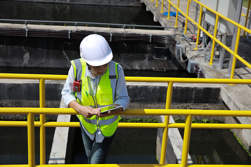 An advanced safety engineer inspects the wastewater system of the waterworks, and Maintenance for the control system of the wastewater treatment system