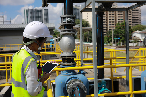 An advanced safety engineer inspects the wastewater system of the waterworks, and Maintenance for the control system of the wastewater treatment system