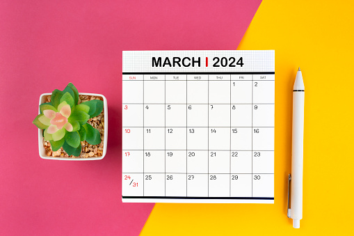 White calendar for March 2024 and pen on beautiful background, planning concept.