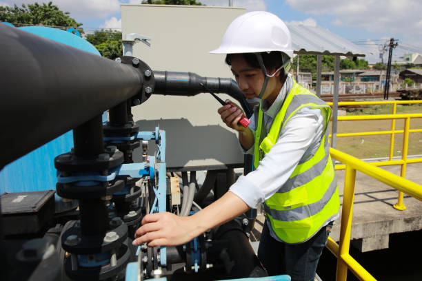 young female engineer check water pump and water treatment system, industrial and factory concept - sewage treatment plant wastewater water pump valve fotografías e imágenes de stock