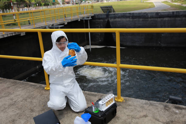 istock Water analysis operator wearing PPE sample and audit water from the water treatment plant, industrial and environment concept 1943363720
