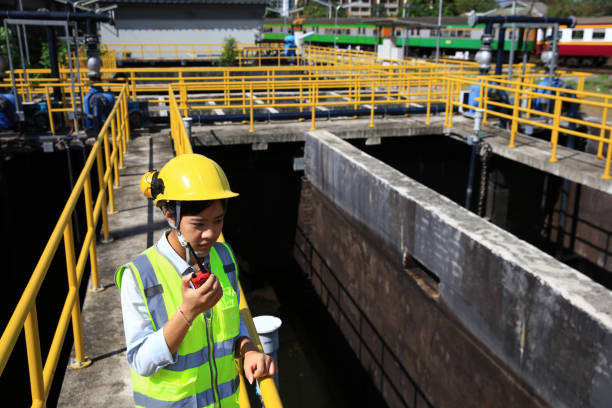istock Environment engineer using radio communication on the wastewater treatment plant. engineer check on the wastewater treatment plant. 1943364265