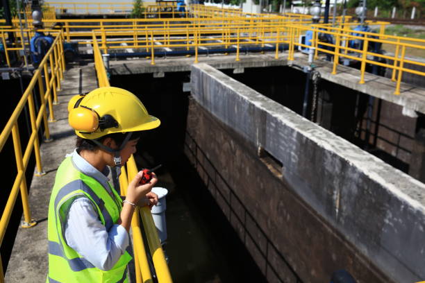 istock Environment engineer using radio communication on the wastewater treatment plant. engineer check on the wastewater treatment plant. 1943364815