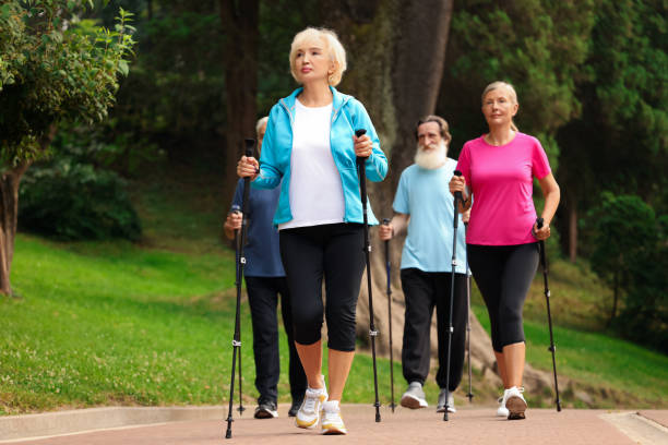 istock Group of senior people performing Nordic walking outdoors. Low angle view 1943397420