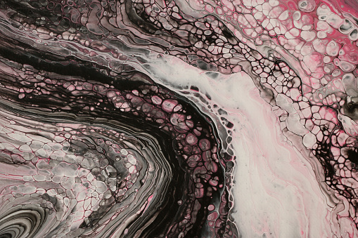 Pink, black, and white abstract water and pebble background