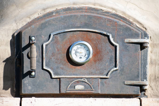 intricate details and textures of the cast iron door as it withstands the intense heat of the oven.