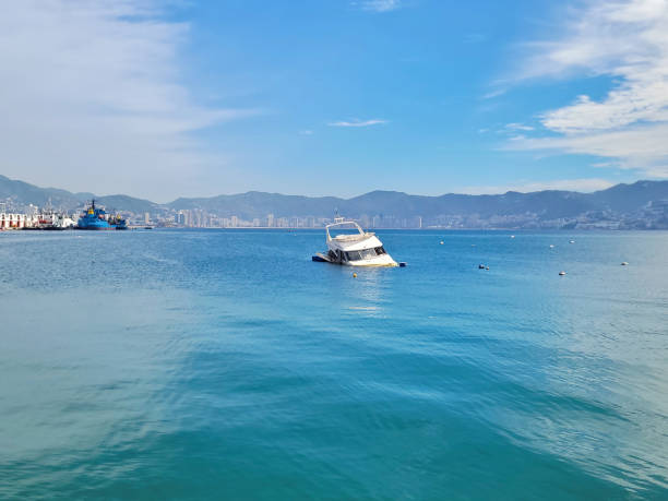 istock Sinking Elegance: Half-Submerged Yacht in Acapulco Bay 1943574675