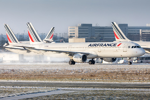 Air France Airbus A321 taxiing at Roissy Charles de Gaulles airport during a snowy day