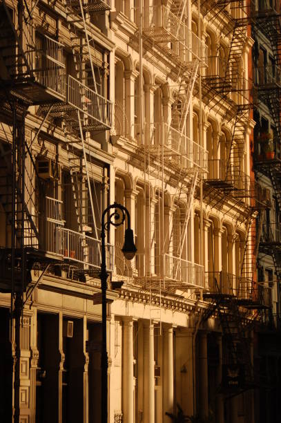 New York, NY, USA July 1, 2007 Warm sunlight bathes the fire escapes and the cast iron architecture of the apartments, art galleries and lofts of Soho in New York Cityscape