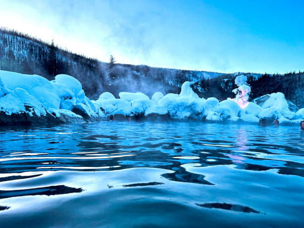 istock Steaming water with a view of snow and mountains 1943661932