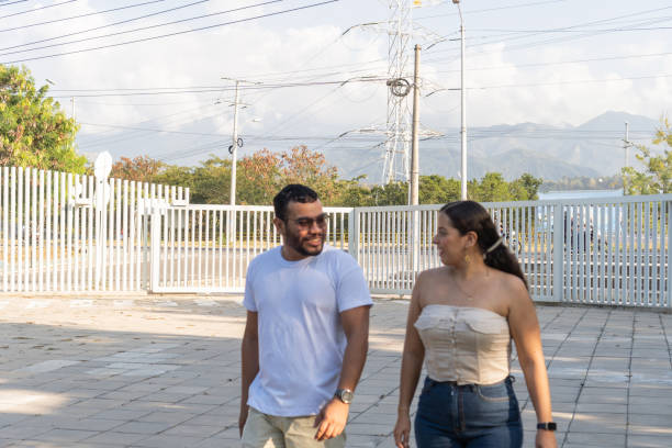 istock Relaxed Couple Walking by Electrical Towers 1943689837