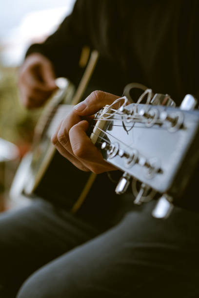 istock Unknown person playing an acoustic guitar. 1943700227