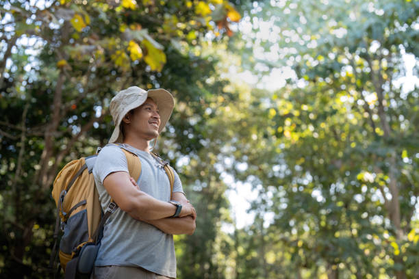 istock Young man asian trekking among trees with backpack, young man enjoy alone in forest. Camping, hiking, travelling, search for adventure concept 1943763189