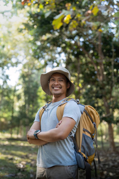 istock Young man asian trekking among trees with backpack, young man enjoy alone in forest. Camping, hiking, travelling, search for adventure concept 1943763194