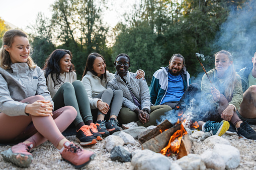 Diverse Group of Friends Enjoying a Campfire Outdoors