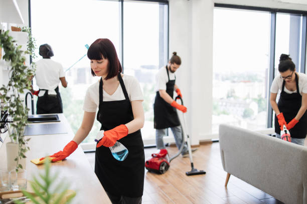 istock Caucasian janitor in apron cleaning table . 1943840812