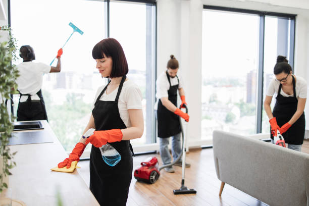 istock Caucasian janitor in apron cleaning table . 1943840818