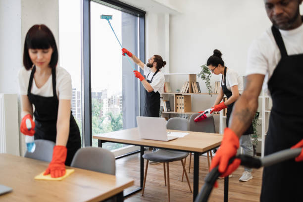 istock People of cleaning service cleans tables, floor, and panoramic windows. 1943842020