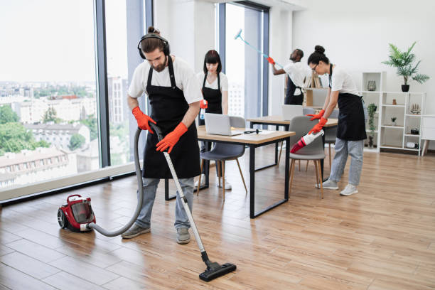 Professional cleaning company. Team of young multicultural cleaners vacuums floor, wipes tables with gadgets, shelves, washes windows in spacious, bright, modern office. Professional cleaning company. workplace absence stock pictures, royalty-free photos & images