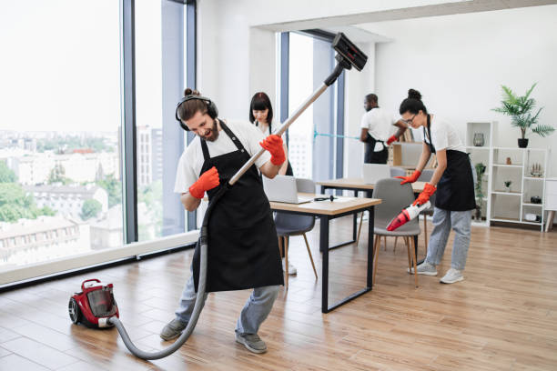 istock Professional cleaner Caucasian man having fun holding vacuum cleaner like guitar 1943842421