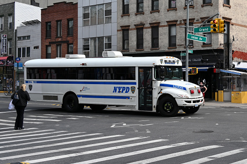 New York City, New York, USA, April 11, 2023 - New York Police Department Bus (NYPD Bus) at the corner of Grand Street and Union avenue in Williamsburg, New York City.