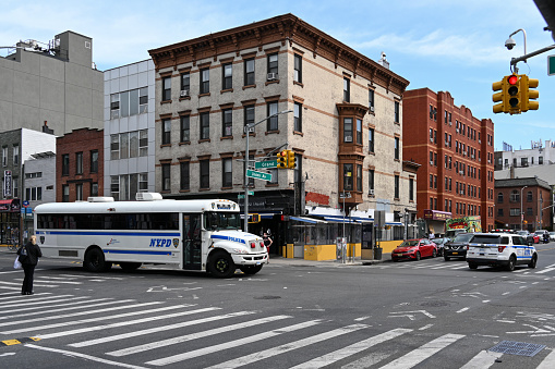 New York City, New York, USA, April 11, 2023 - New York Police Department Bus (NYPD Bus) at the corner of Grand Street and Union avenue in Williamsburg, New York City.