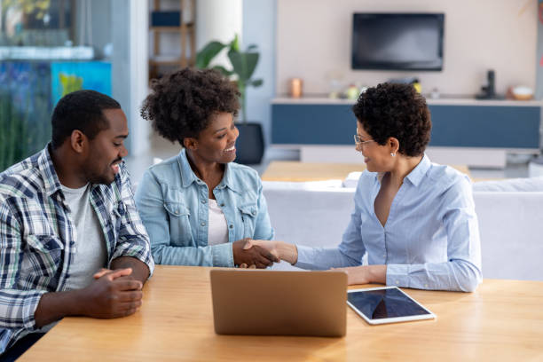 istock Happy couple at home talking to a financial advisor 1943859384