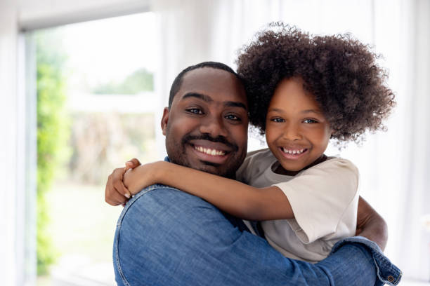 istock Happy father and daughter smiling at home 1943860438