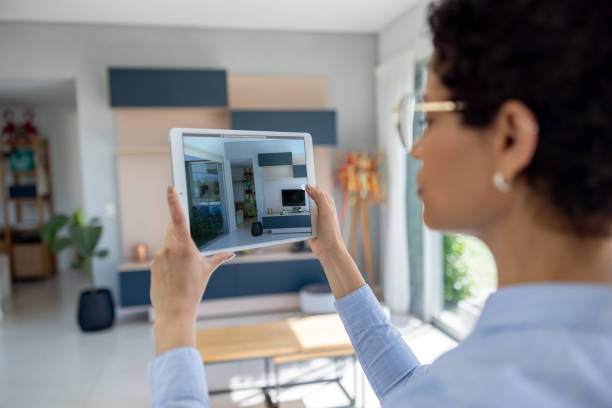 istock Real estate agent taking photos of a house using a digital tablet 1943860975