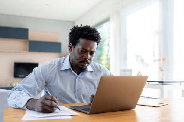 istock Businessman working at home on his laptop 1943863652