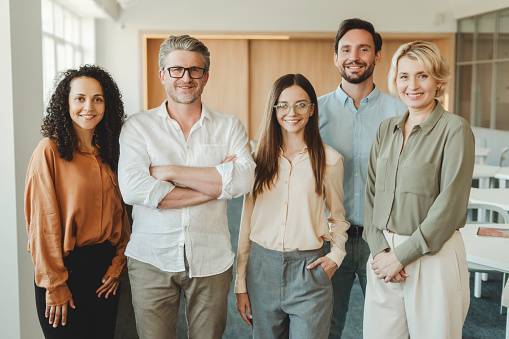 Portrait of multi ethnic business team looking at camera in the office