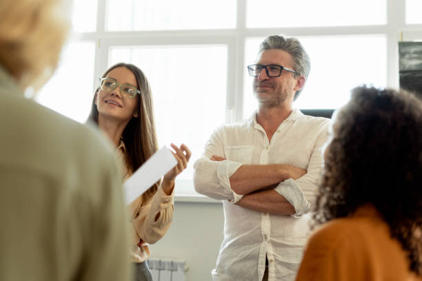 istock Group of confident businesspeople working in modern office talking, brainstorming, planning strategy 1943864197