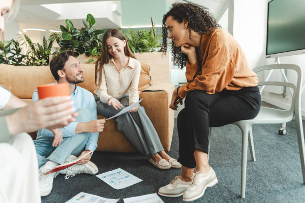 istock Group of confident businesspeople working together holding graphs in modern office 1943865271
