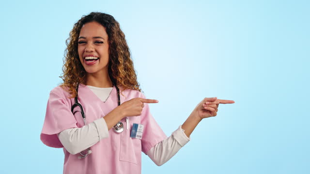 Doctor, woman and point in studio, space and mockup with smile on face for medical review by blue background. Nurse, medic and happy in portrait for feedback, choice and decision for health promotion