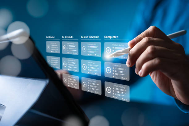 istock Planner and project handle application. Businessman or manager uses a tablet with responsible methodology boards and a virtual interface screen. Process, workflow, task list, due date management tool. 1943913598