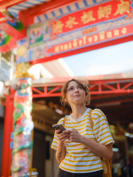 istock Woman using smartphone exploring Chinatown in Bangkok 1943953922