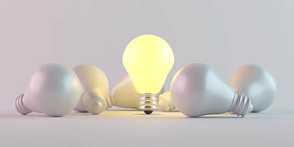 Illuminated light bulb standing Out in Crowd. Creative idea and inspire innovation. 3d rendering