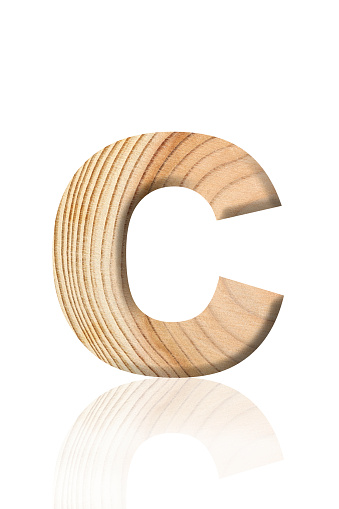 Close-up of three-dimensional tree ring alphabet letter C on white background.
