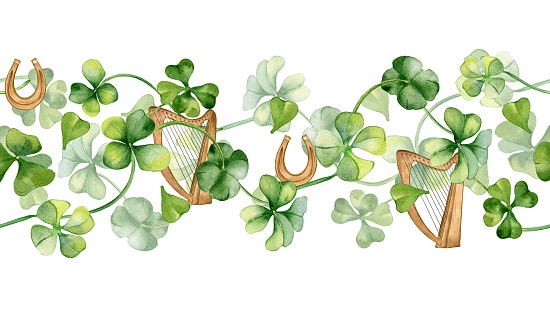 Seamless border with harp and shamrock watercolor illustration isolated on white. Painted clover and horseshoe. Hand drawn Irish symbol. Design for St.Patricks day postcard, package, web banner.