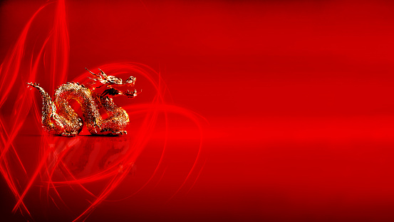 Gold dragon isolated on red background with vibrant light effect and copy space, Year of the dragon Chinese new year 2024 concept.