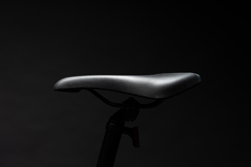 Black mountain bicycle on black background close up photo