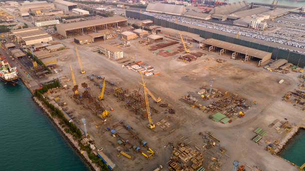 istock Construction port at harbor cranes at sunset. Shipyard at sunset. Making big drilling rig contruction on port. 1944110759