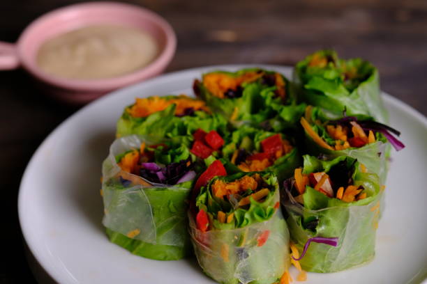 istock Spring rolls are a rolled appetizer or dim sum commonly found in Chinese and Asian cuisine. Raw fresh vegetable salad roll with mayonnaise. 1944165509