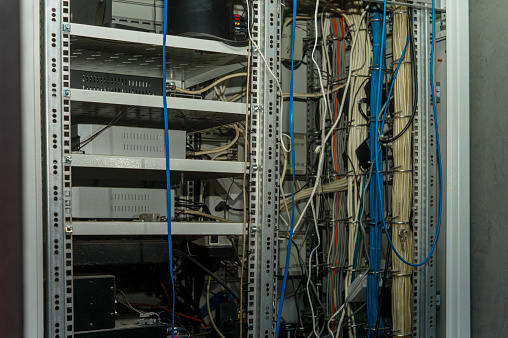 server rack with electronic stuff and cables, indoor shot, no people