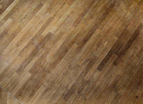 office wooden floor made of tropical wood that ages gradually turns gray. pressure impregnated, from short angled pieces stacked together like parquet. follows pavement in an arch, geometric, formal, recolor, parquetry, texture, laminate plastic