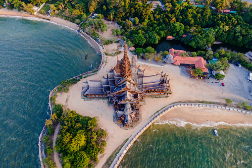 The Sanctuary of Truth wooden temple in Pattaya Thailand is a gigantic wooden construction located at the cape of Naklua Pattaya City Chonburi Thailand at sunset dusk