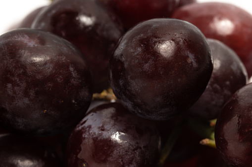 Close-up detail of fresh organic red grapes delicious fruit isolated on white background clipping path
